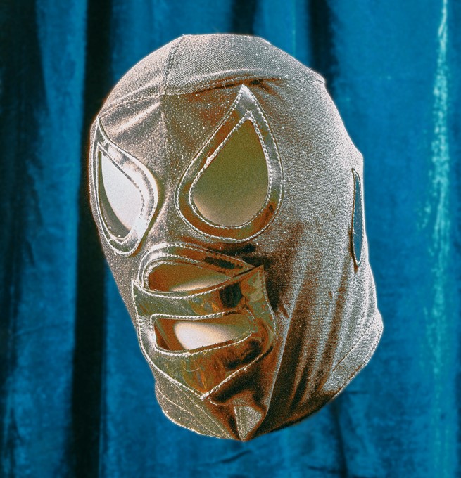 Gold bondage mask in-front of a blue sheet